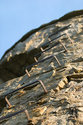 Hand Holds Up The Stone Wall