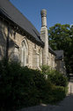 Side Angled View Of The Church With A Stone Chimney
