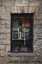 Pub Window With Antiques On The Shelf