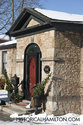 Entrance With Red Door And Stone Walls
