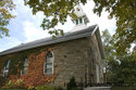 Side Of The Stone School With Colourful Vines